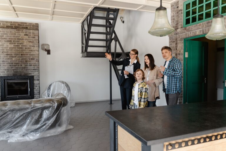 Real estate agent showing a house to a family with a young kid