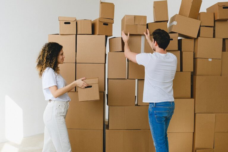 A person exchanging cardboard boxes.