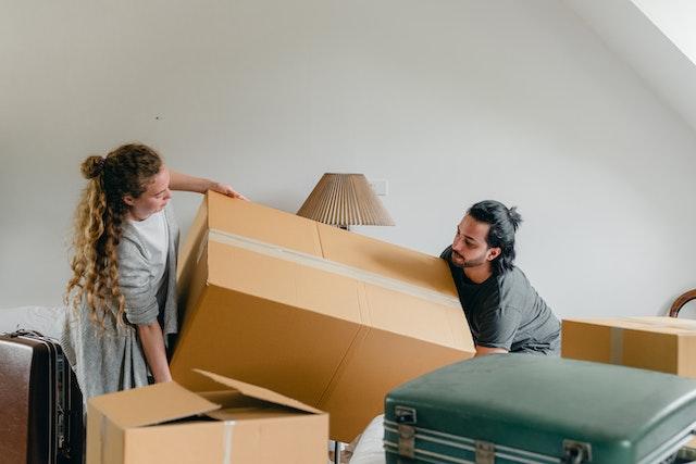 Two people lifting a box