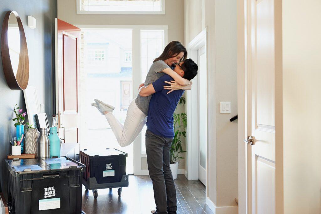 couple hugging near home entrance