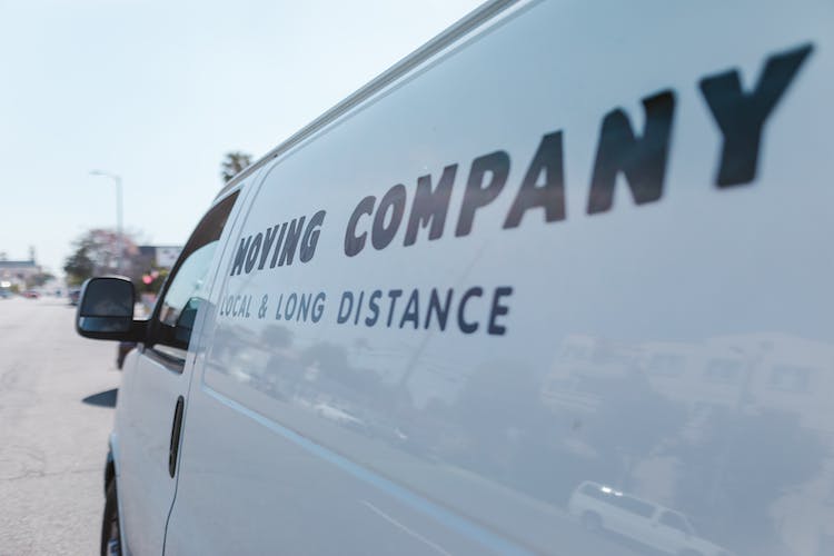 Close-up of a white moving van on the street