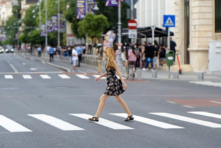 A woman is crossing the street