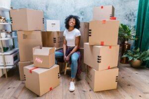 Woman surrounded by moving boxes as she prepares for a move